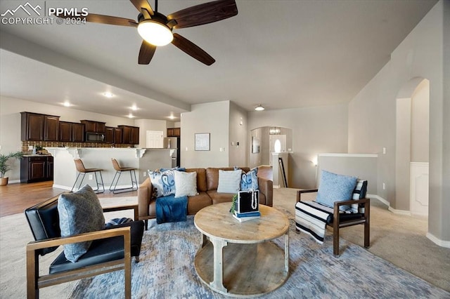 carpeted living room featuring ceiling fan