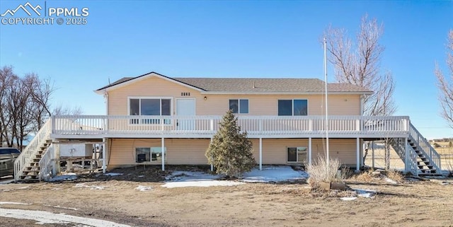 rear view of property with a deck and stairway