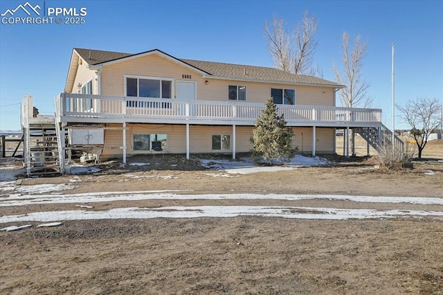 view of front of home with a deck and stairway