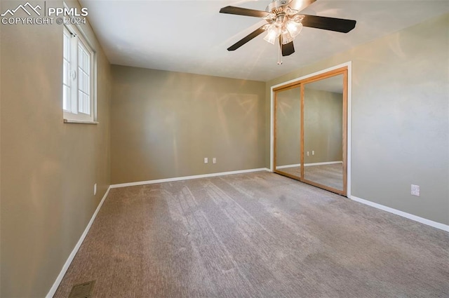 unfurnished bedroom featuring ceiling fan, a closet, and carpet floors