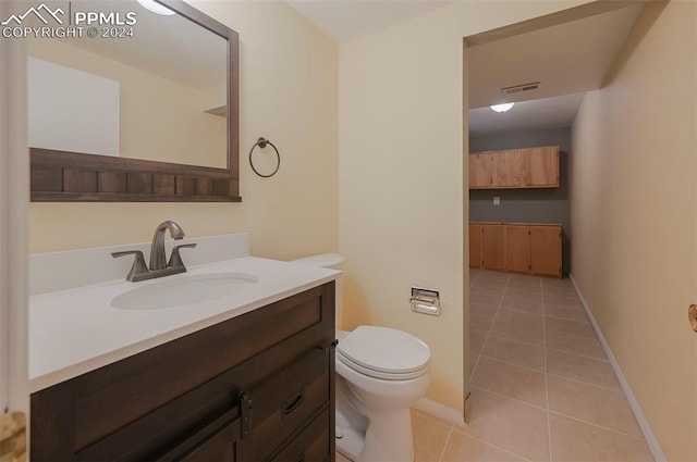 bathroom featuring toilet, vanity, and tile patterned floors