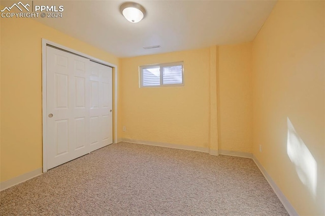 unfurnished bedroom featuring carpet flooring and a closet