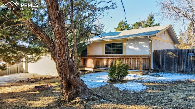 snow covered property with a wooden deck