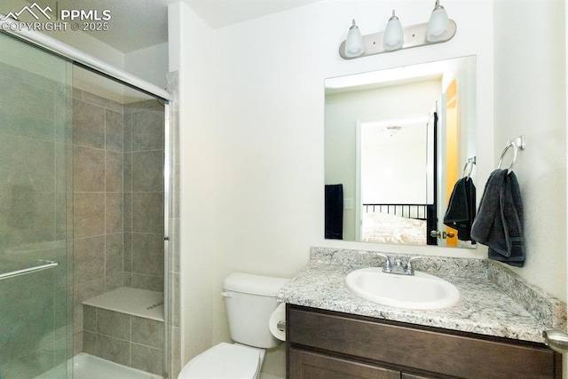 bathroom featuring vanity, toilet, and walk in shower