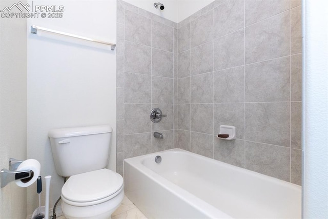 bathroom featuring tiled shower / bath and toilet