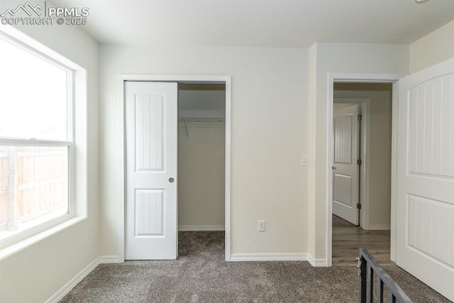 unfurnished bedroom with a closet and carpet