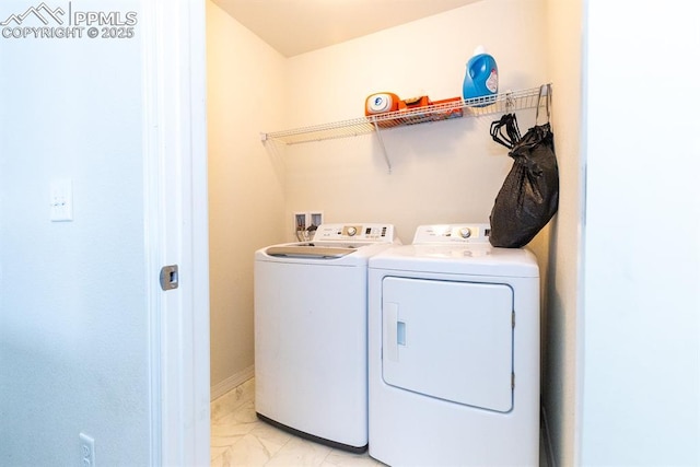 clothes washing area with washing machine and dryer