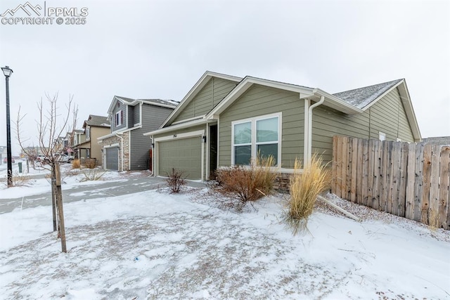 view of snow covered exterior featuring a garage