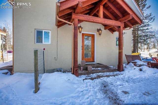 view of snow covered property entrance