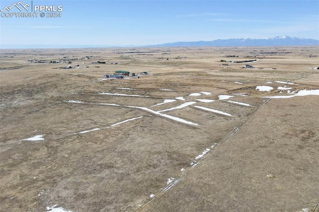 birds eye view of property with a mountain view and a rural view