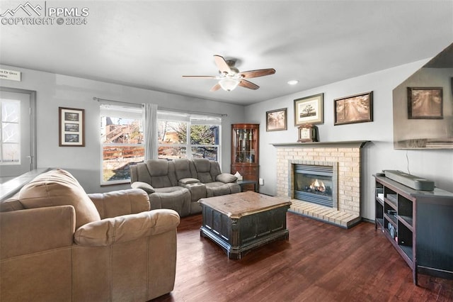 living room featuring a fireplace, ceiling fan, and dark hardwood / wood-style flooring