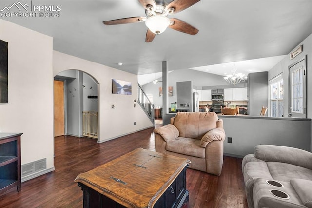 living room with ceiling fan with notable chandelier, dark hardwood / wood-style flooring, and lofted ceiling