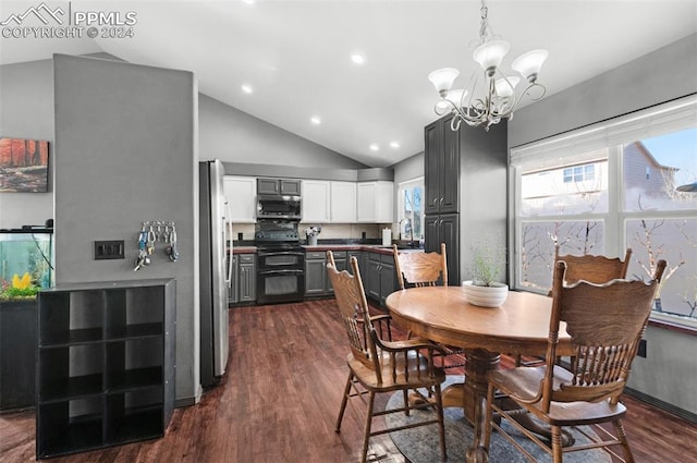 dining room with a chandelier, dark hardwood / wood-style flooring, sink, and vaulted ceiling