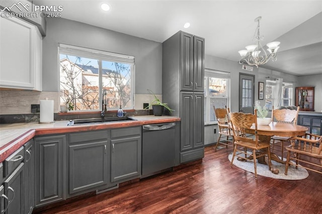 kitchen featuring dishwasher, gray cabinets, a notable chandelier, and sink