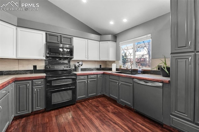 kitchen with gray cabinets, white cabinets, stainless steel appliances, and lofted ceiling