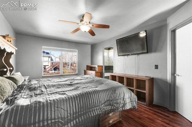 bedroom with dark hardwood / wood-style flooring and ceiling fan