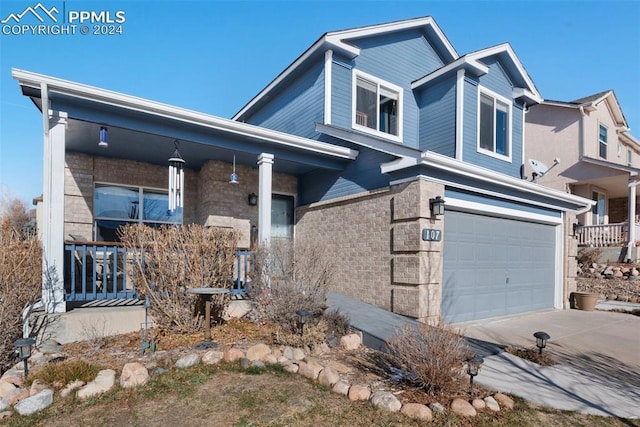 view of front of home featuring a porch and a garage