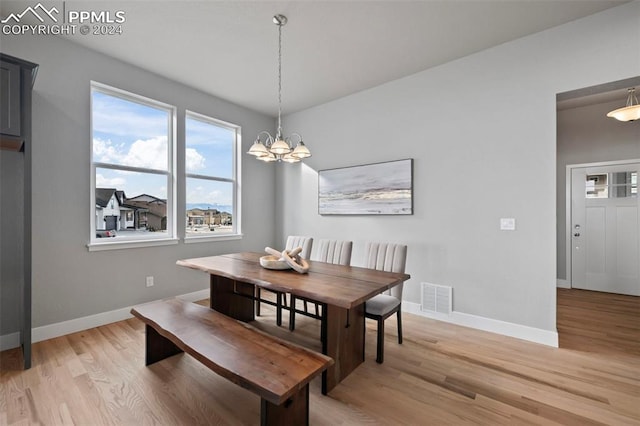 dining space featuring a chandelier and light hardwood / wood-style floors