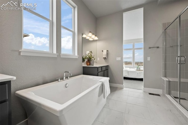 bathroom featuring vanity and independent shower and bath