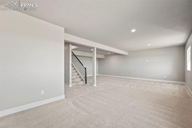 basement featuring light carpet