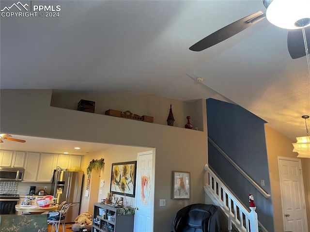 living room featuring ceiling fan and vaulted ceiling