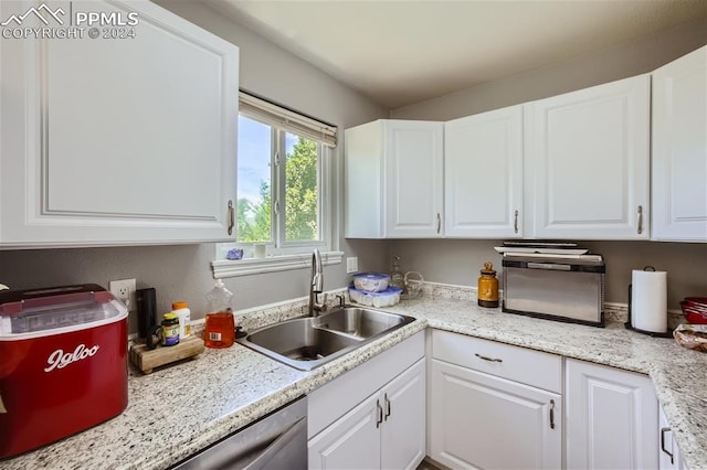 kitchen with white cabinetry and sink