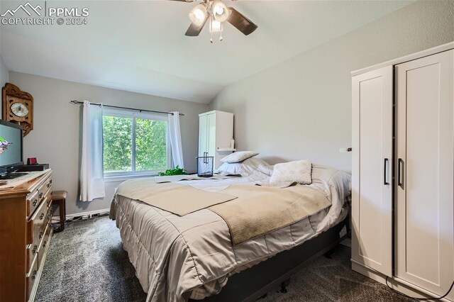 bedroom featuring dark colored carpet, ceiling fan, and lofted ceiling