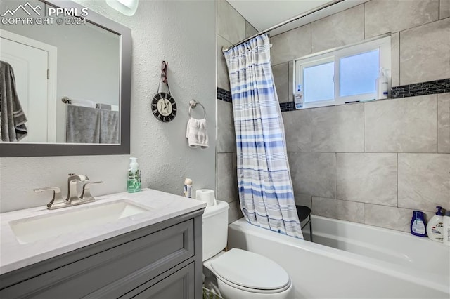 full bathroom with shower / bath combo with shower curtain, vanity, and toilet