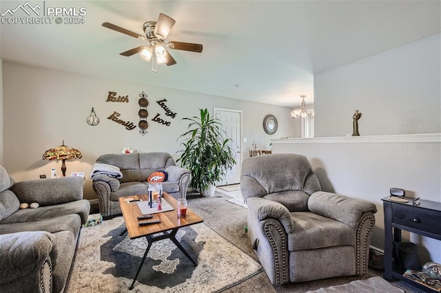 living room with ceiling fan with notable chandelier and carpet floors