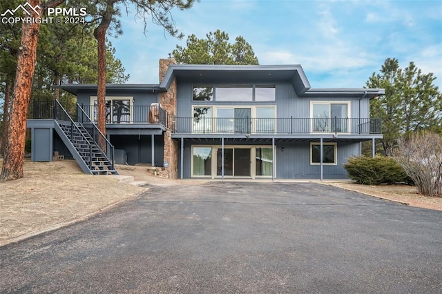 rear view of property featuring a wooden deck