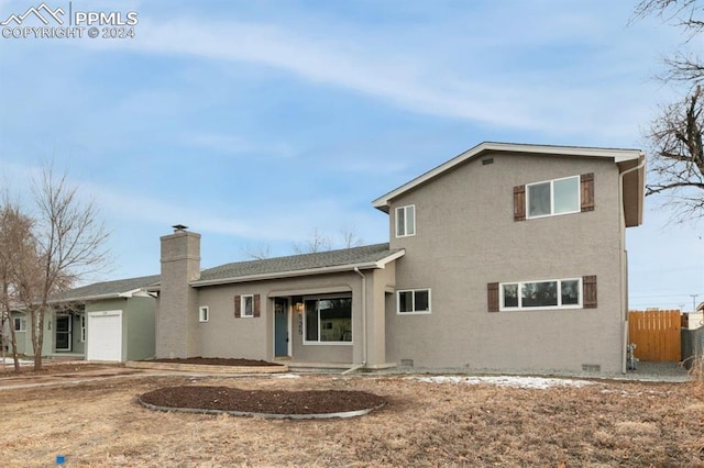 back of property featuring a garage