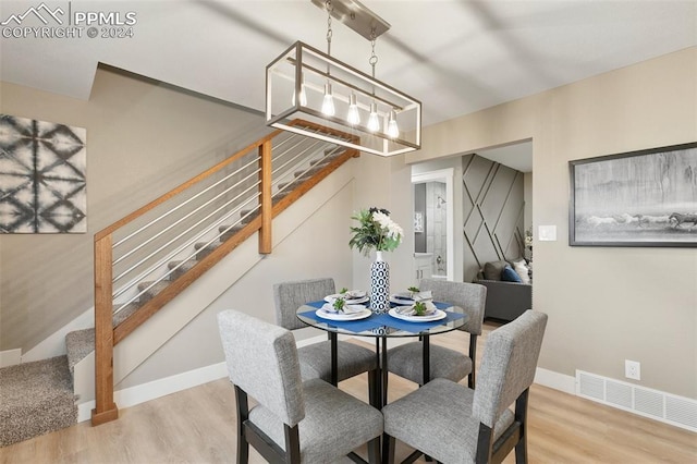 dining space with a chandelier and hardwood / wood-style floors