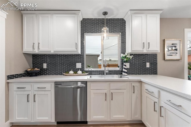 kitchen with pendant lighting, dishwasher, white cabinets, and sink