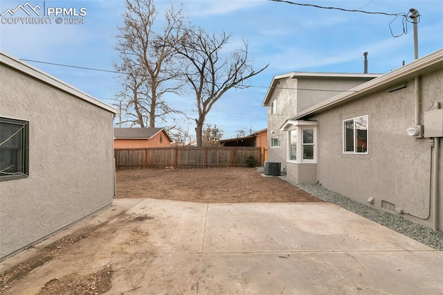 view of yard featuring central AC and a patio