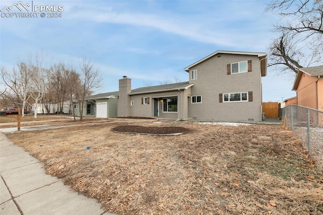 back of property featuring a garage