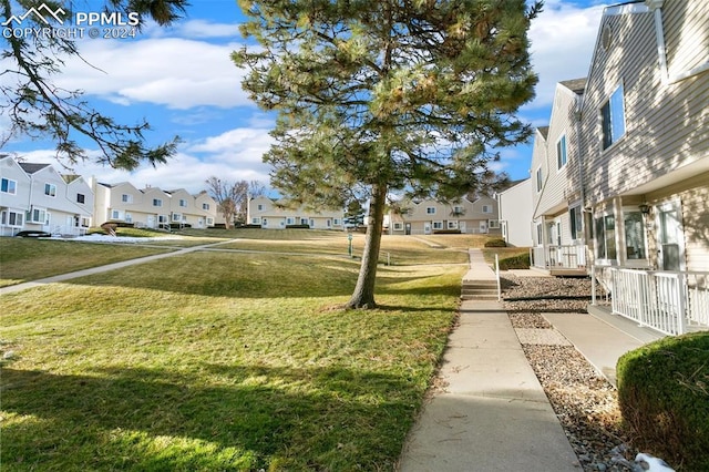 view of property's community with a lawn