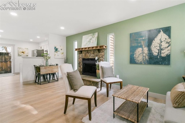 living room featuring light hardwood / wood-style floors and a fireplace