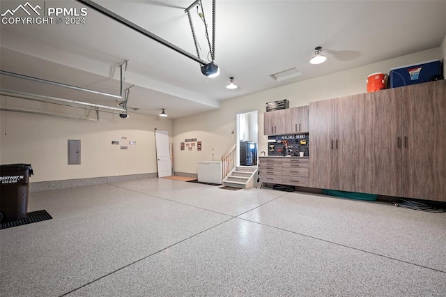 garage with electric panel, a garage door opener, and ceiling fan