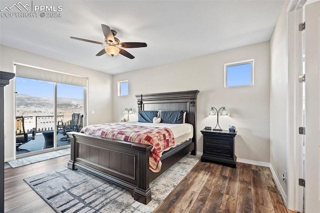 bedroom featuring a mountain view, access to outside, ceiling fan, and dark hardwood / wood-style floors