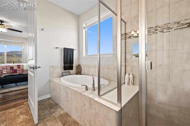 bathroom featuring ceiling fan and independent shower and bath