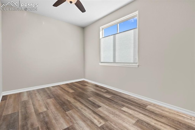 spare room with hardwood / wood-style flooring and ceiling fan