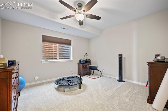 interior space with ceiling fan and light colored carpet