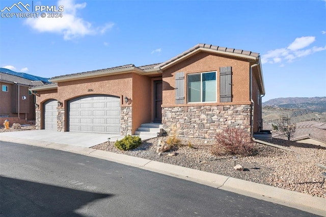 view of front of property with a mountain view and a garage