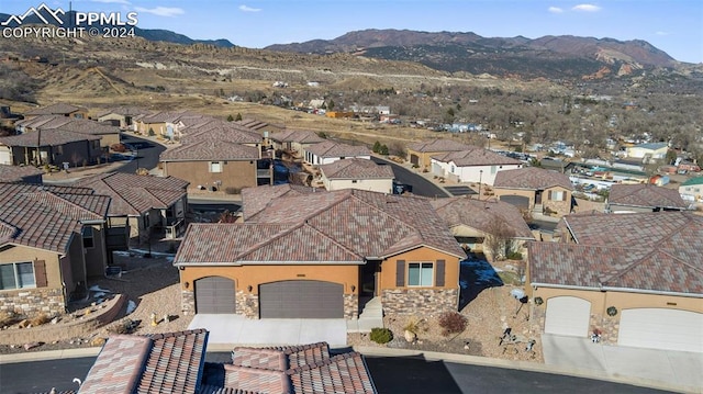 birds eye view of property with a mountain view