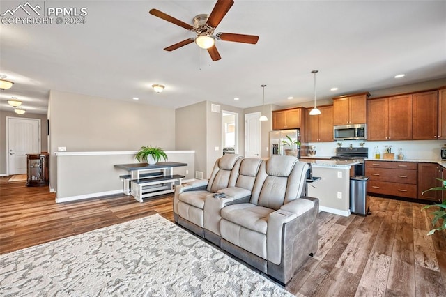 living room featuring ceiling fan and dark hardwood / wood-style flooring