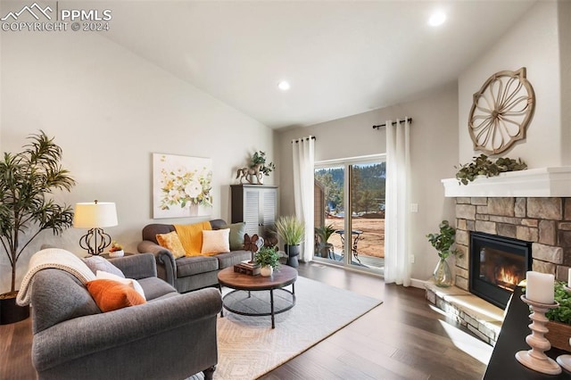 living room featuring a stone fireplace, dark wood-type flooring, and vaulted ceiling