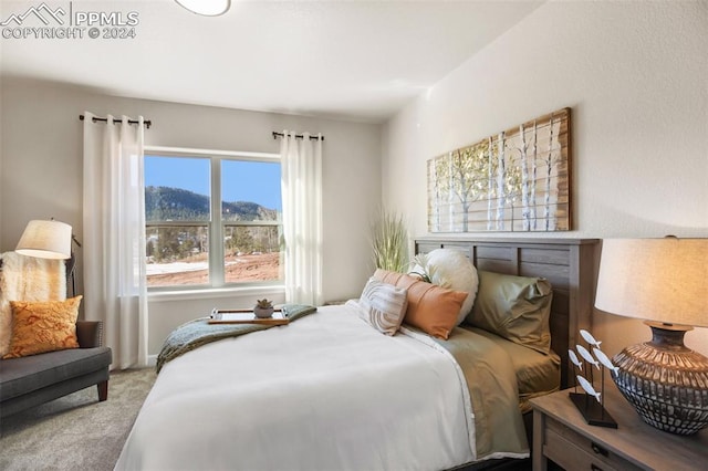 bedroom with a mountain view and carpet