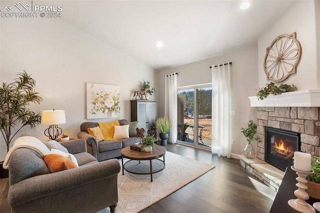 living room featuring a fireplace, dark hardwood / wood-style floors, and vaulted ceiling