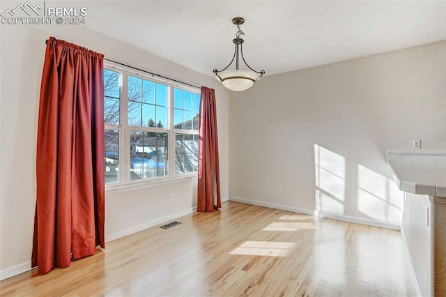 unfurnished dining area with light hardwood / wood-style flooring