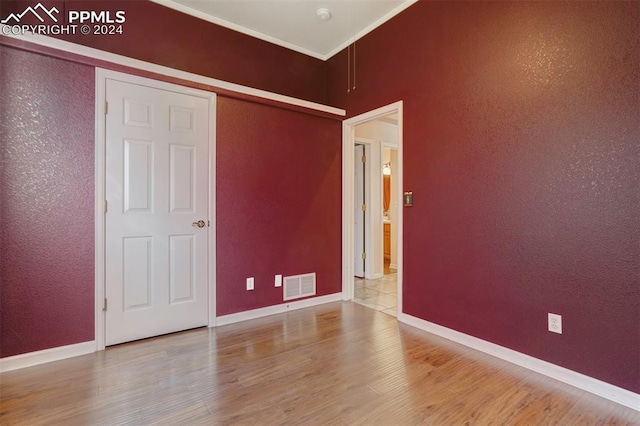 unfurnished bedroom with wood-type flooring